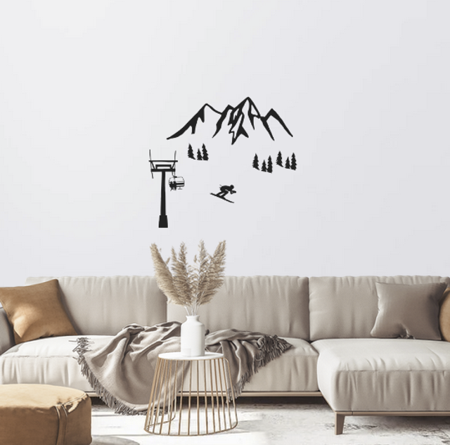 Silhouette d'une chaine de montagnes et d’un skieur alpin