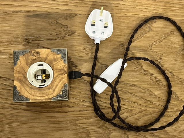 Rustic bedside lamp made of olive wood.