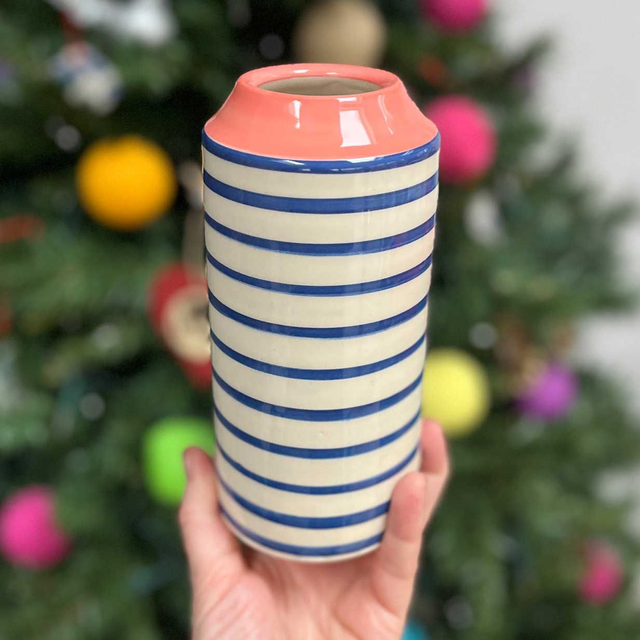 Blue striped vase with muted deep pink colour pop top