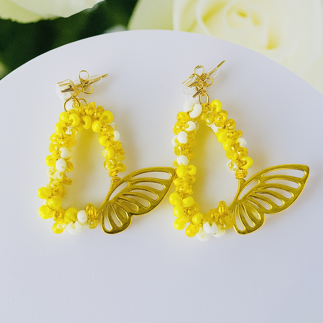 Butterglow Drops – Gele Kralenoorbellen met Gouden Vlinderaccent
