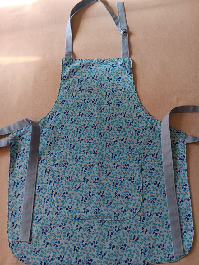 Childs Kitchen/Play Apron  Blue Bows Cotton Fabric with Front pocket and pale blue lining, waist ties and adjustable neck tie