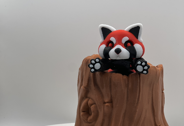 Red panda in lockable tree stump! 