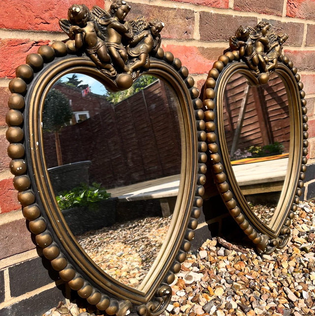 A Pair Of Vintage Plaster Wall Mirrors Adorned With Putti