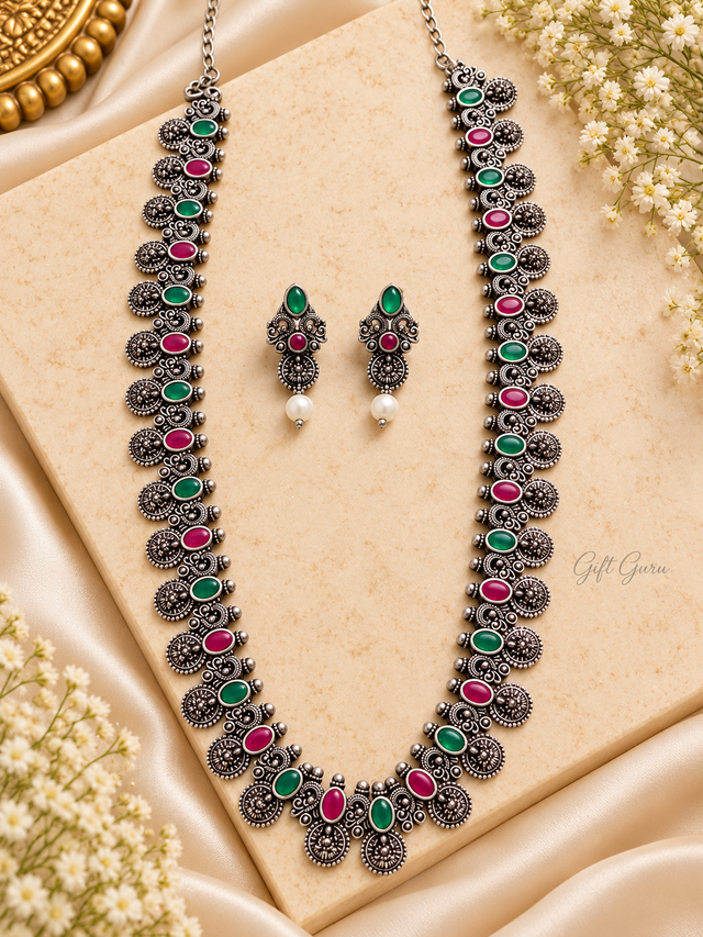 Long necklace (haram) paired with small stud earrings featuring pearl drops