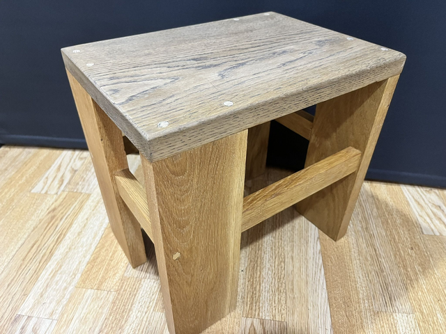 Oak cantilever stool made of solid oak wood in two colors.