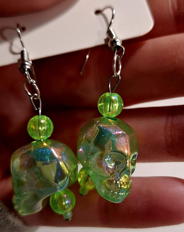 Green skull drop earrings