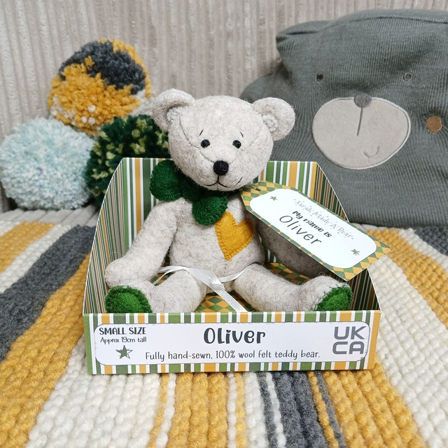 Oliver. Small size, handmade teddy bear. UKCA. Tray base packaging. Standard Wool Felt. Beige. Green. Mustard.