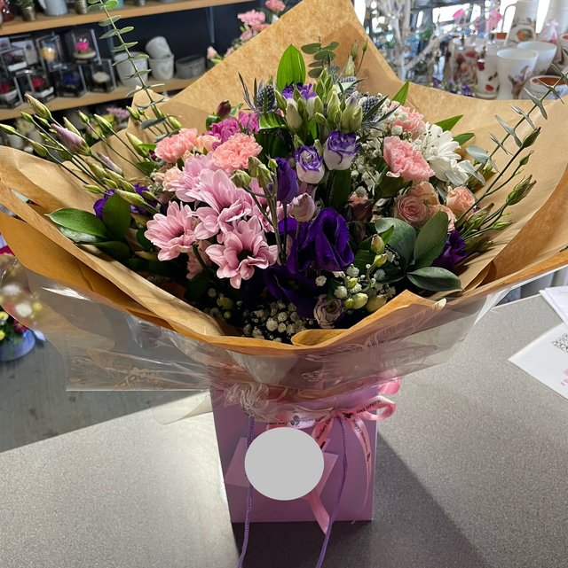 Mixed flower hand tied aqua pack bouquet 