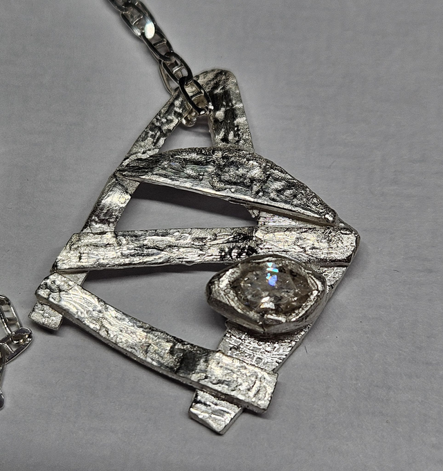 Abstract 'gate' with clear navette cubic zirconia pendant 