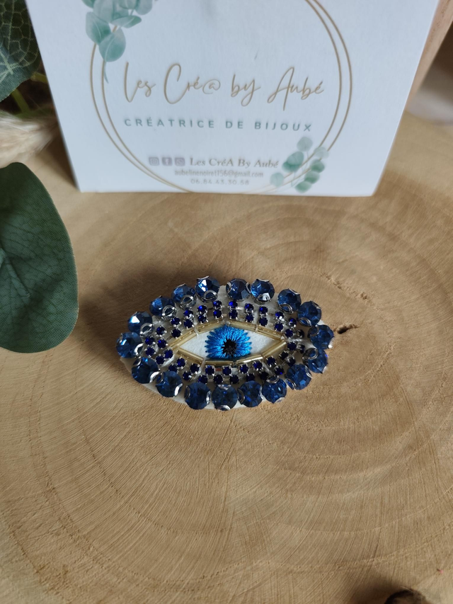 BROCHE OEIL STRASS BLEU 0001351