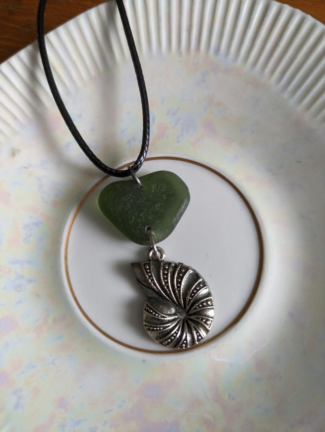 Green sea glass with silver fossil