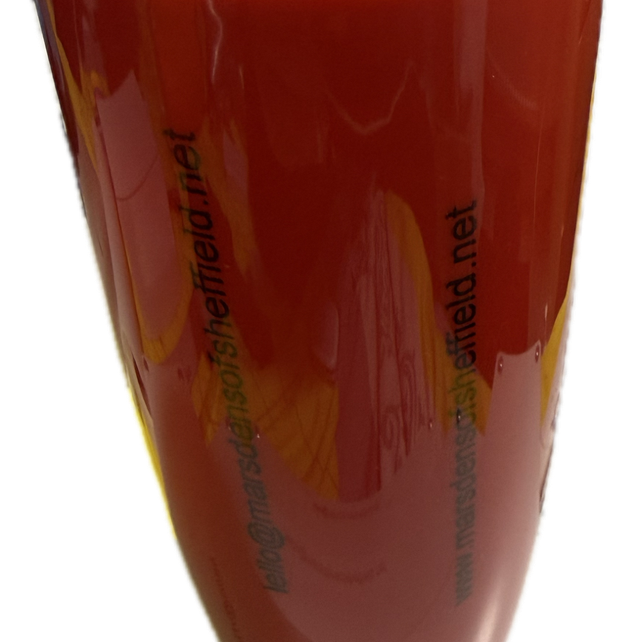 Orange or red solid plastic drinking cup with seal tight lid and open and closing spout on top.