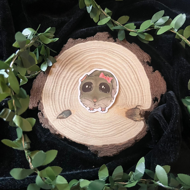 Sticker hamster llorando con lazo