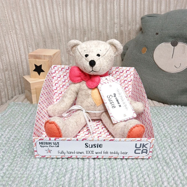 Susie. Medium size, handmade teddy bear. UKCA. Tray base packaging. Standard Wool Felt. Beige. Coral. Orange. Sorbet Pink.  