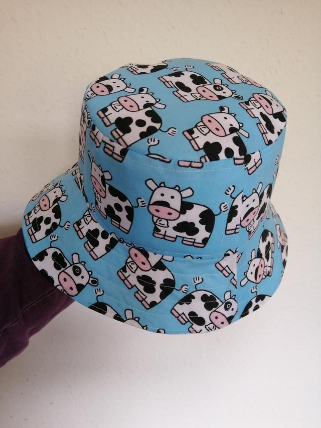 Hat - approx. 2-4 yrs.   Light blue cows