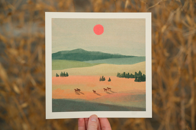 horses running under a red sun