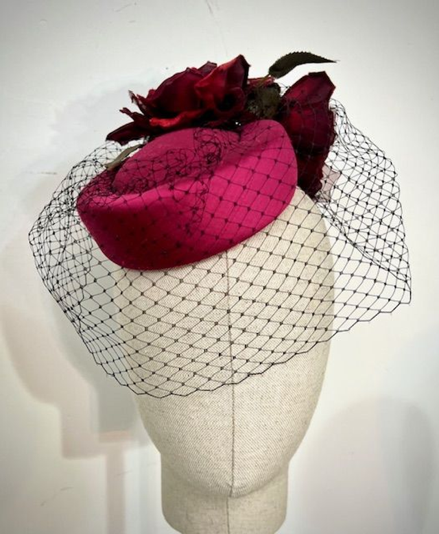 Ruby silk shantung percher with veil and roses