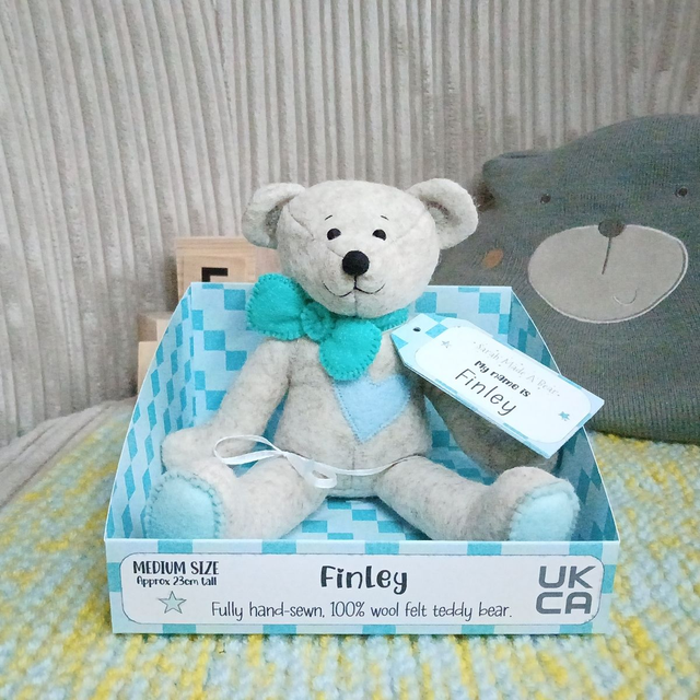 Finley. Medium size, handmade teddy bear. UKCA. Tray base packaging. Standard Wool Felt. Beige. Blue. Turquoise. Spearmint.
