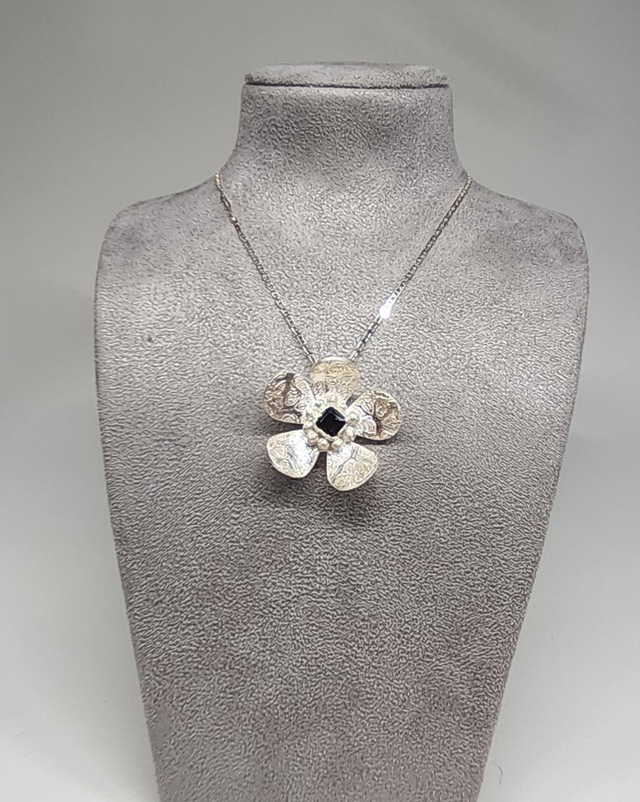 Bee print flower pendant with dark emerald cubic zirconia on silver necklace