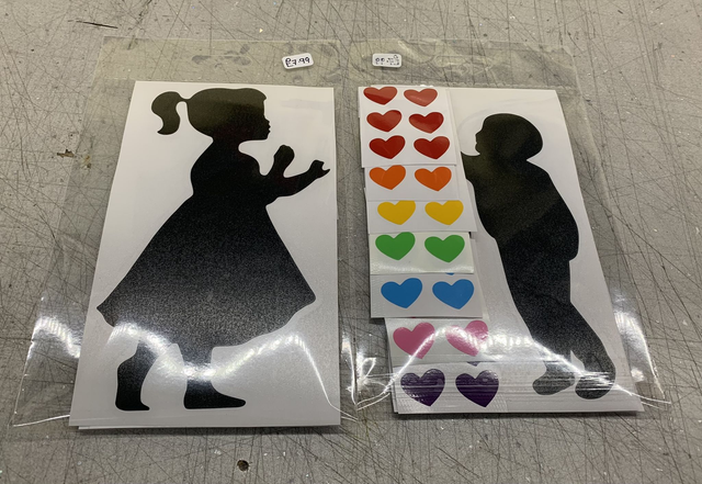 Children's silhouettes with rainbow hearts