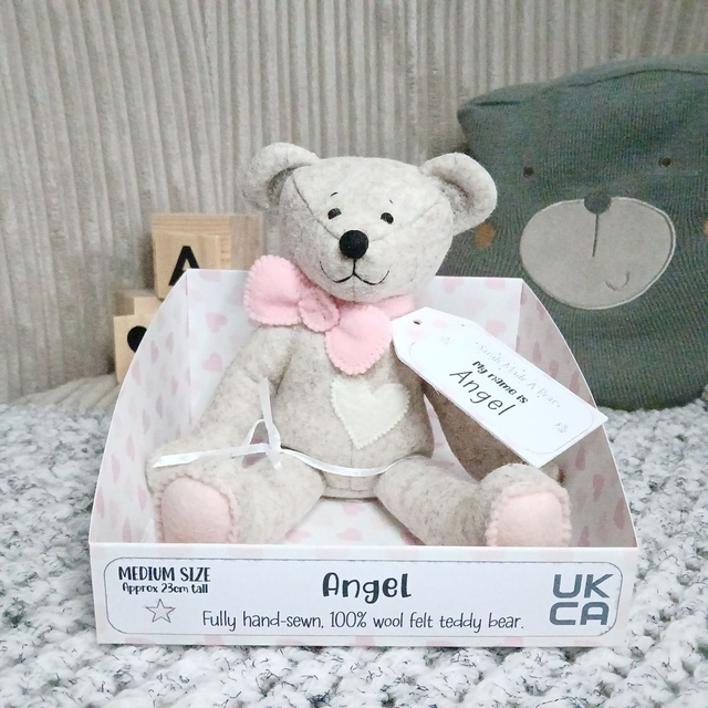 Angel. Medium size, handmade teddy bear. UKCA. Tray base packaging. Standard Wool Felt. Baby pink, cream and blush.