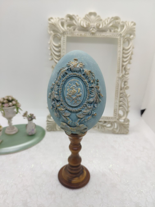 Blue cameo Goose egg on a wooden stand 