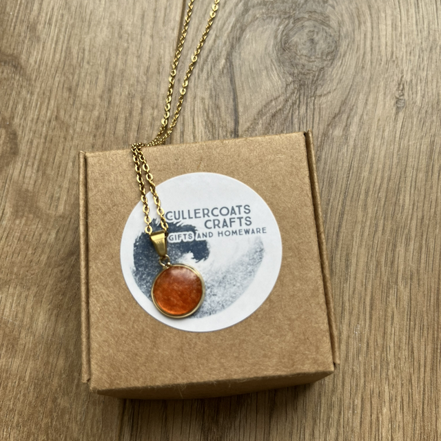 Amber resin charm on gold necklace 