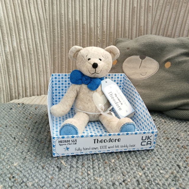 Theodore. Medium size, handmade teddy bear. UKCA. Tray base packaging. Standard Wool Felt. Beige. Blue. White.