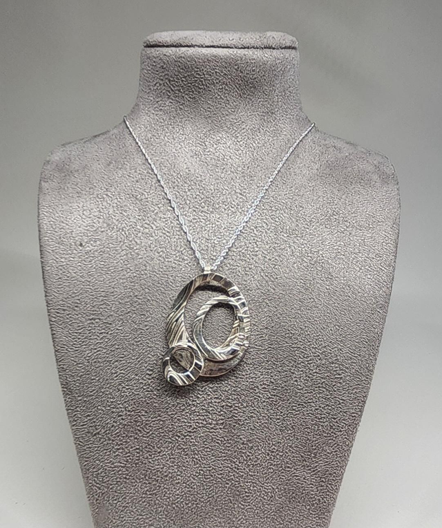 Three ring pendant on silver necklace 