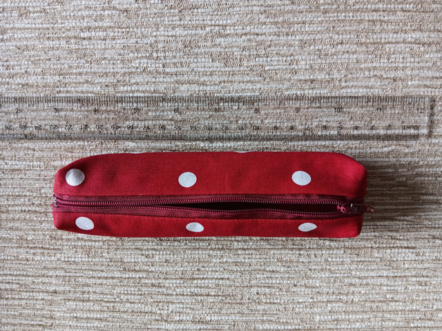 Small Box Shaped Cosmetic Bag Red background with white spots, Red Waterproof Lining, and Red Zip.