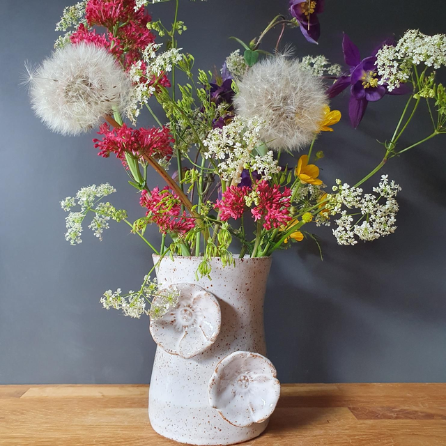 Speckled vase with poppy embellishment 