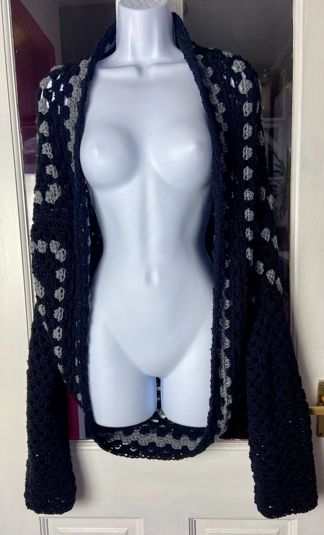 Grey and black shrug style cardigan.