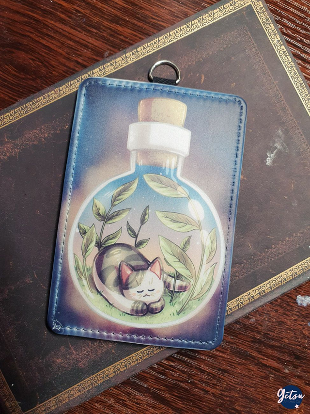 Porte-carte chat dans une fiole ronde