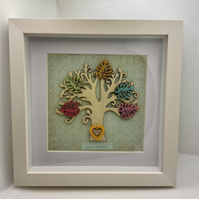 Wooden tree frame with colourful wooden leaves. Sweet moments quote. 