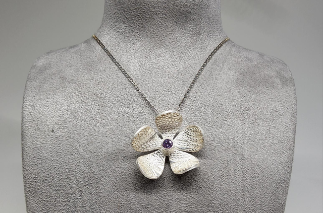 Wheat design textured flower pendant with lilac cubic zirconia on silver necklace