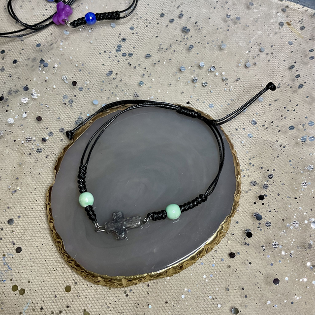 Adjustable bracelet with quartz cross. Fully adjustable cord bracelet.