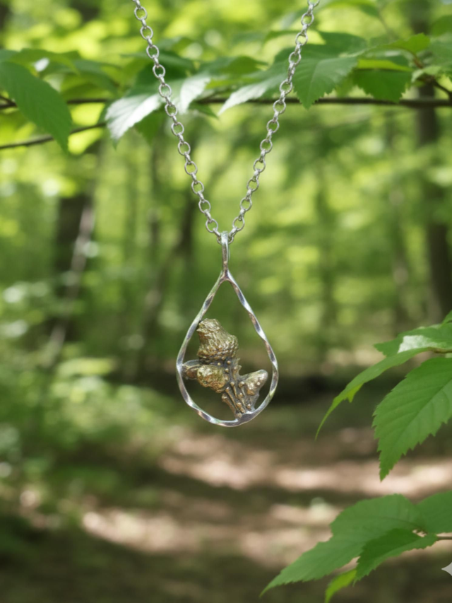 Bronze Pine branch in silver teardrop pendant