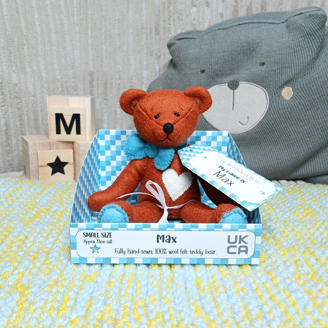 Max. Small size, handmade teddy bear. UKCA. Tray base packaging. Standard Wool Felt. Reddish-Brown. Blue. Cream.