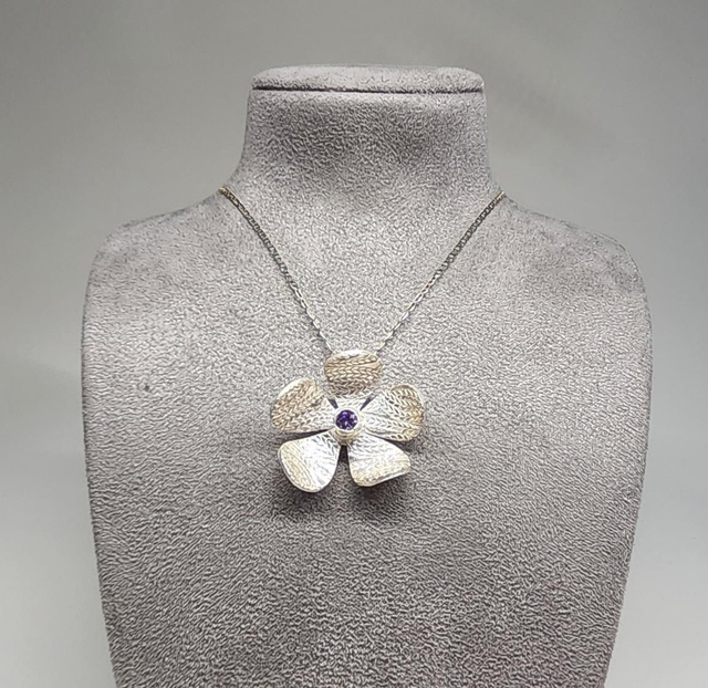 Wheat design textured flower pendant with lilac cubic zirconia on silver necklace