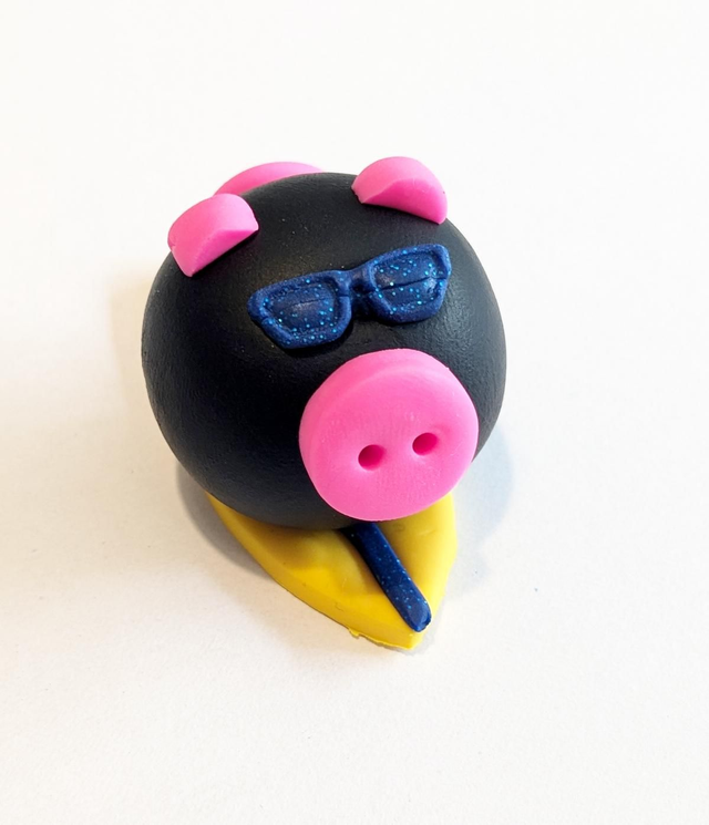 Black surfing pig