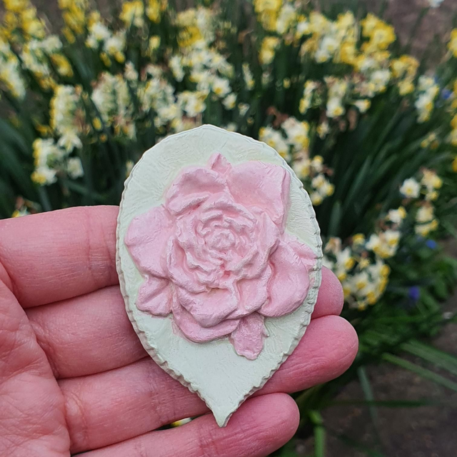 Pink rose on leaf badge