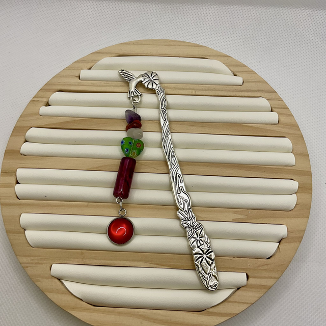 Metal bookmark with Christmas beads and charms.