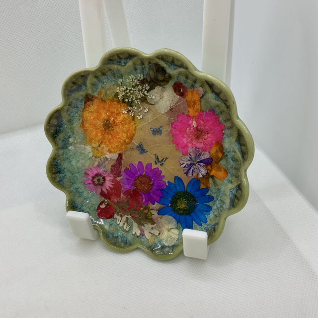 Green ring trinket tray with pressed flowers and resin.