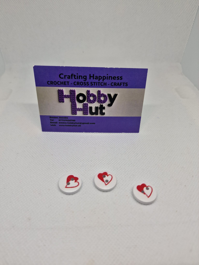 White Buttons With One White And One Red Heart