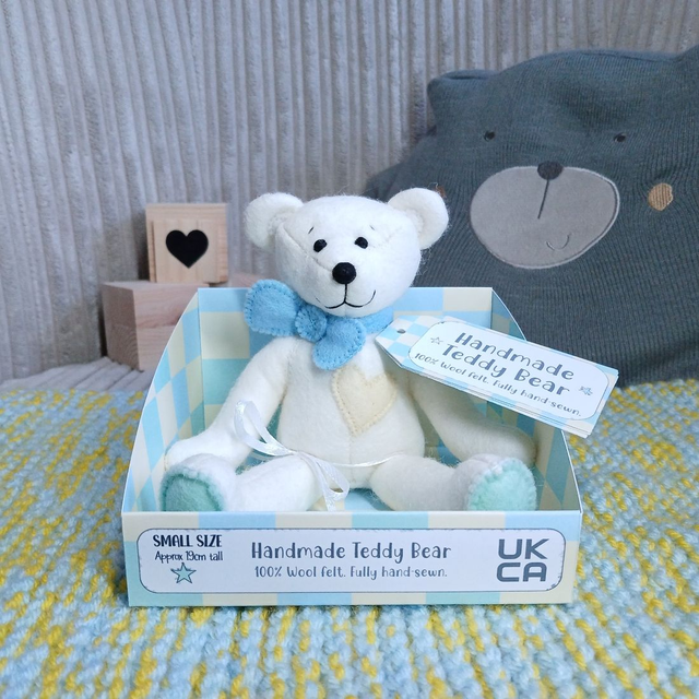 Cream bear. *No name*. Small size, handmade teddy bear. UKCA. Tray base packaging. Standard Wool Felt. Pastel green, blue & yellow.