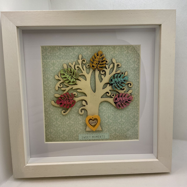 Wooden tree frame with colourful wooden leaves. Sweet moments quote.
