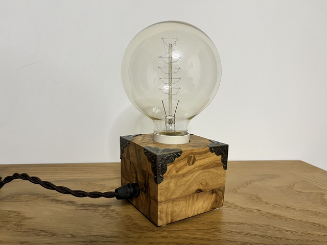 Rustic bedside lamp made of olive wood.