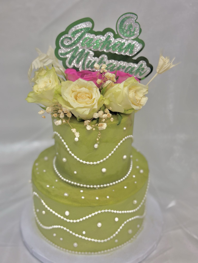 Green 2 tier Birthday Cake adorned with pearls &amp; fresh flowers