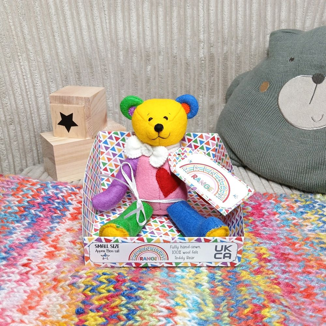 Rainbow. Small size, handmade teddy bear. UKCA. Tray base packaging. Standard Wool Felt. Bright rainbow. White. Blue. Orange. Red. Yellow. Green.