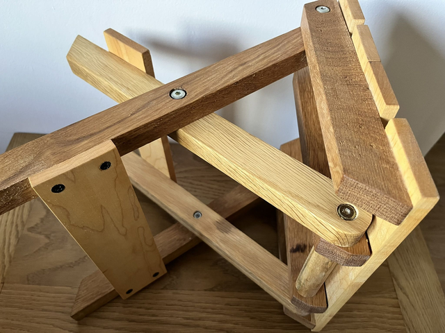 Wooden, folding camping stool made of oak and maple wood.